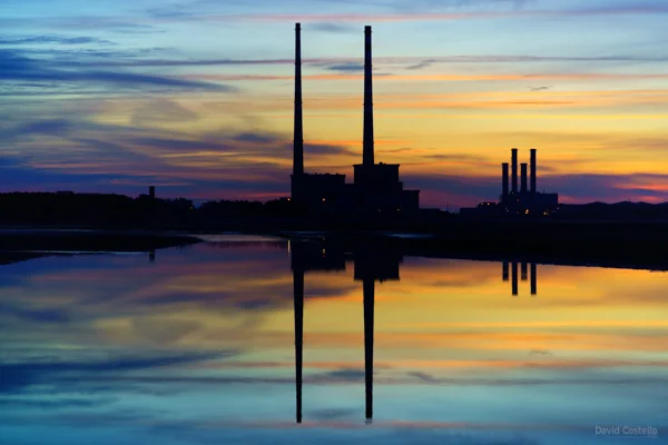 Poolbeg Towers reflecting a colourful Summer dawn sky in Dublin Bay.